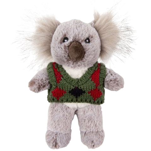 Plush toy koala wearing a green sweater with red diamond patterns on a white background