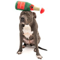 Fuzzyard Holiday Champagne Dog Toy | Lifestyle Image of Pitbull with Green Plush Champagne Bottle